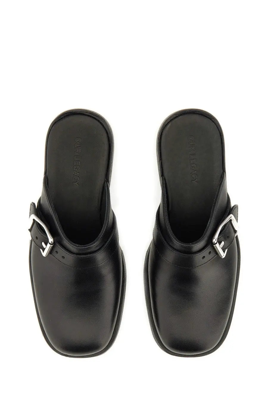 Our legacy men’s mule camion black black leather mules with silver toned buckle details front view