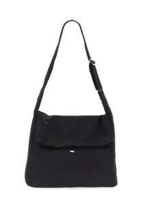 Our Legacy men’s sling bag black nylon with a sleek minimalist design and adjustable shoulder strap