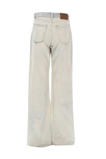 Wide-leg light faded wash denim jeans with subtle distressing and brown leather patch on waistband from our legacy women