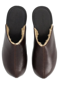 Brown leather clog-style slippers with light shearling lining and our legacy branding on the insole