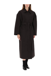 Our Legacy women’s trench coat Churchill black with a black belt, structured collar, and long sleeves