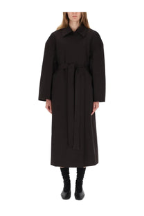 Our Legacy women’s black trench coat Churchill features a black belt and structured collar with long sleeves