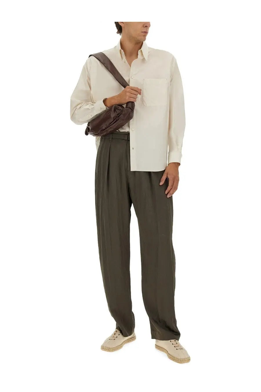 Brown leather crossbody bag with sleek minimalist design and adjustable strap paired with lemaire men’s beige cotton and silk shirt