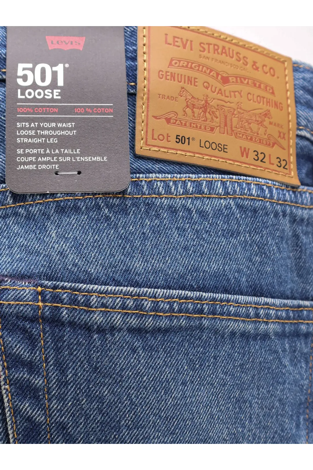 Levi’s men’s blue denim jeans with a brown leather patch and black tag featuring the 501 loose model back view
