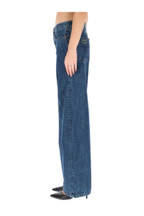 Blue denim wide-leg jeans with classic five-pocket design showing wrangler label on back right pocket