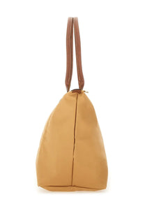 Longchamp women’s borsa le pliage large beige tote bag with tan leather handles and smooth durable fabric body