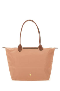 Beige Longchamp Le Pliage tote bag with brown leather handles and gold-tone logo in a Longchamp women’s large blue collection