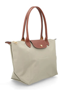 Beige longchamp le pliage medium tote bag with brown leather handles and flap for women in grey collection