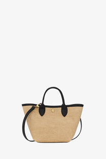 Beige woven straw tote bag with black leather handles and trim shown with Longchamp Le Panet Pliage XS Raffia and Leather crossbody bag black