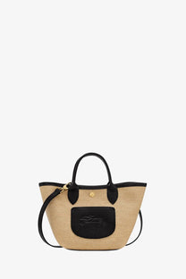 Beige woven straw tote with black leather handles trim and front patch in longchamp women’s le panet pliage xs style