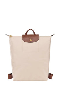 Beige Longchamp womens LE Pliage backpack with brown leather accents and gold tone hardware in pink product image