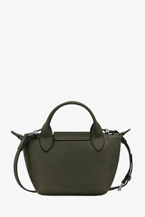 Olive green Longchamp Le Pliage mini handbag with structured silhouette and signature top handles in leather