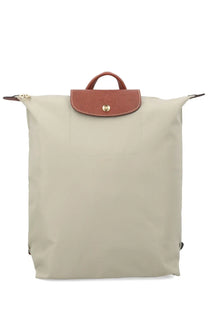 Beige longchamp le pliage medium backpack with brown leather flap and gold tone logo button for women