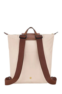 Beige longchamp women’s zaino le pliage backpack with brown leather straps and gold-tone hardware in white