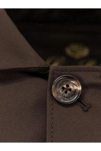 A silver-toned four-hole button engraved with zoro plano on a loro piana men’s sebring waterproof bronze coat