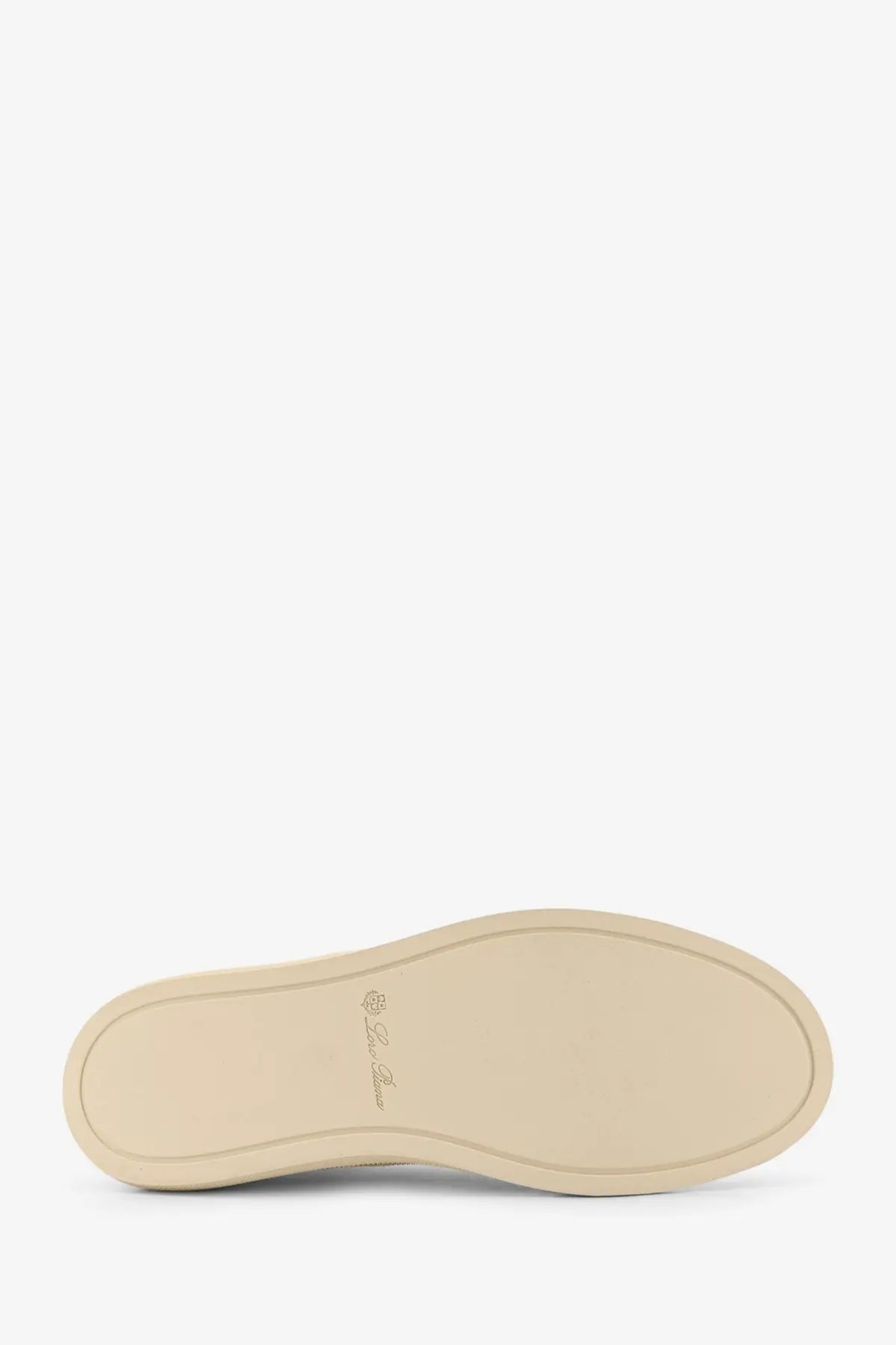 Beige rubber sole with subtle embossed logo on the back of loro piana women’s white canvas sneakers