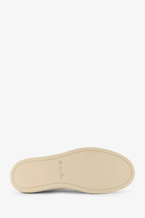 Beige rubber sole with subtle embossed logo on the back of loro piana women’s white canvas sneakers