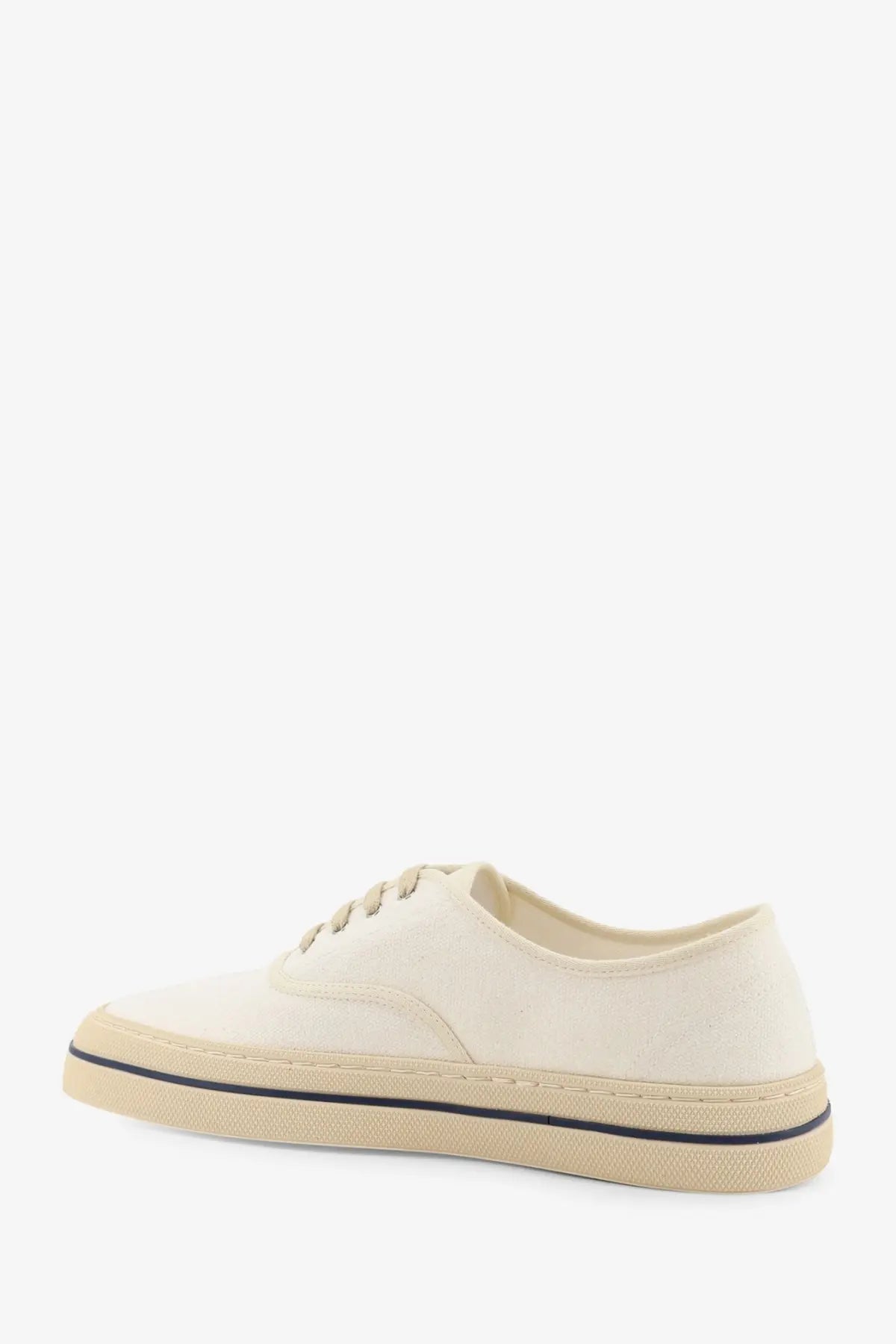 Loro Piana women’s cream-colored canvas sneakers with beige rubber sole and black stitching along the edge