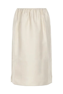 Cream-colored high-waisted midi skirt by Loulou De Saison with smooth satin finish and subtle side slits