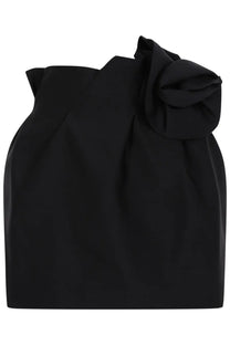 Magda butrym women’s black satin miniskirt with dramatic ruffled bow detail at the shoulder