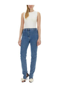 Magda butrym women’s white crochet bra paired with high-waisted blue denim jeans with straight-leg cut and front zipper fly