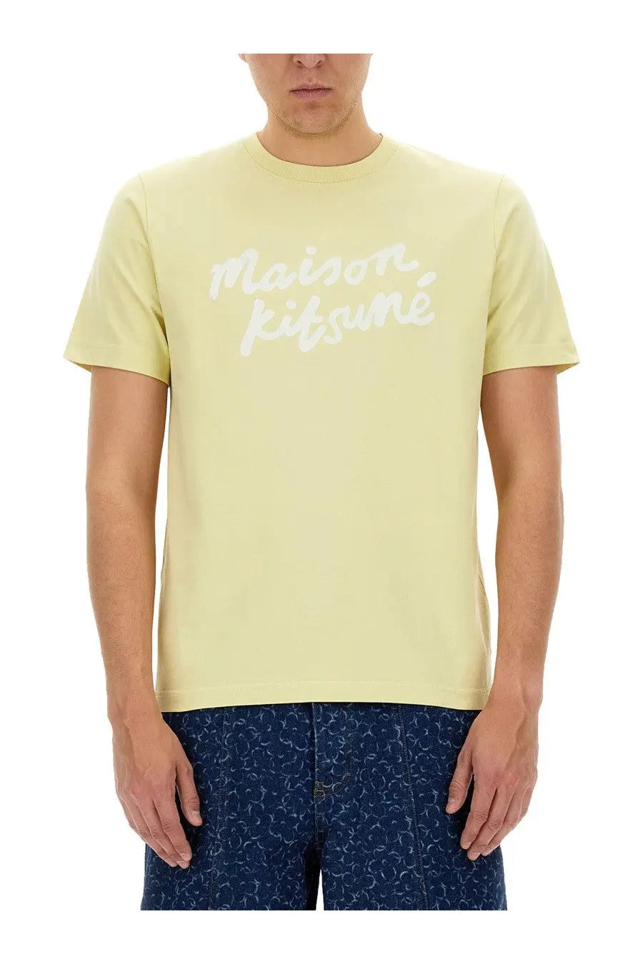 Maison Kitsuné men’s beige t-shirt featuring a pale yellow color and white cursive logo across the chest