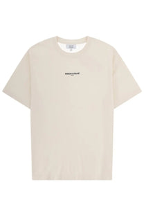 Cream-colored maison kitsuné men’s t-shirt with minimalist black embroidery on the chest in soft cotton material