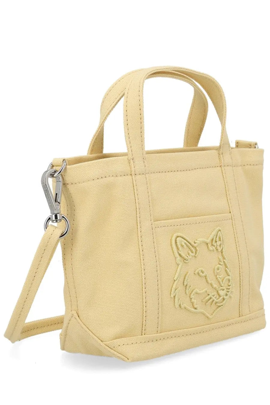 Maison kitsuné women’s beige canvas mini tote bag with stitched fox face emblem on front pocket and silver hardware