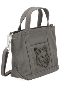 Maison Kitsuné women’s gray canvas mini tote bag featuring a debossed fox face on the front pocket