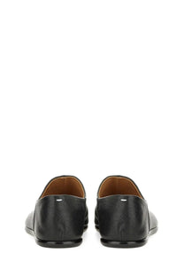 Maison Margiela men’s black leather tabi mules with subtle texture and tan lining for stylish comfort