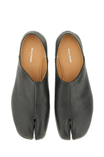 Maison Margiela men’s black leather tabi mules with minimalist design and tan leather insole