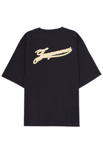 Back view of black oversized t shirt with cream embroidered jaguar logo paired with maison margiela men’s silver necklace