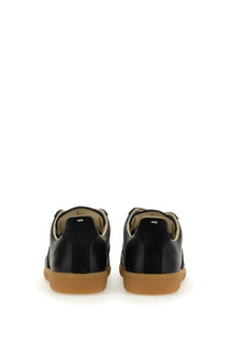 Maison Margiela men’s replica sneaker black with black patent leather, tan rubber soles, and beige lining