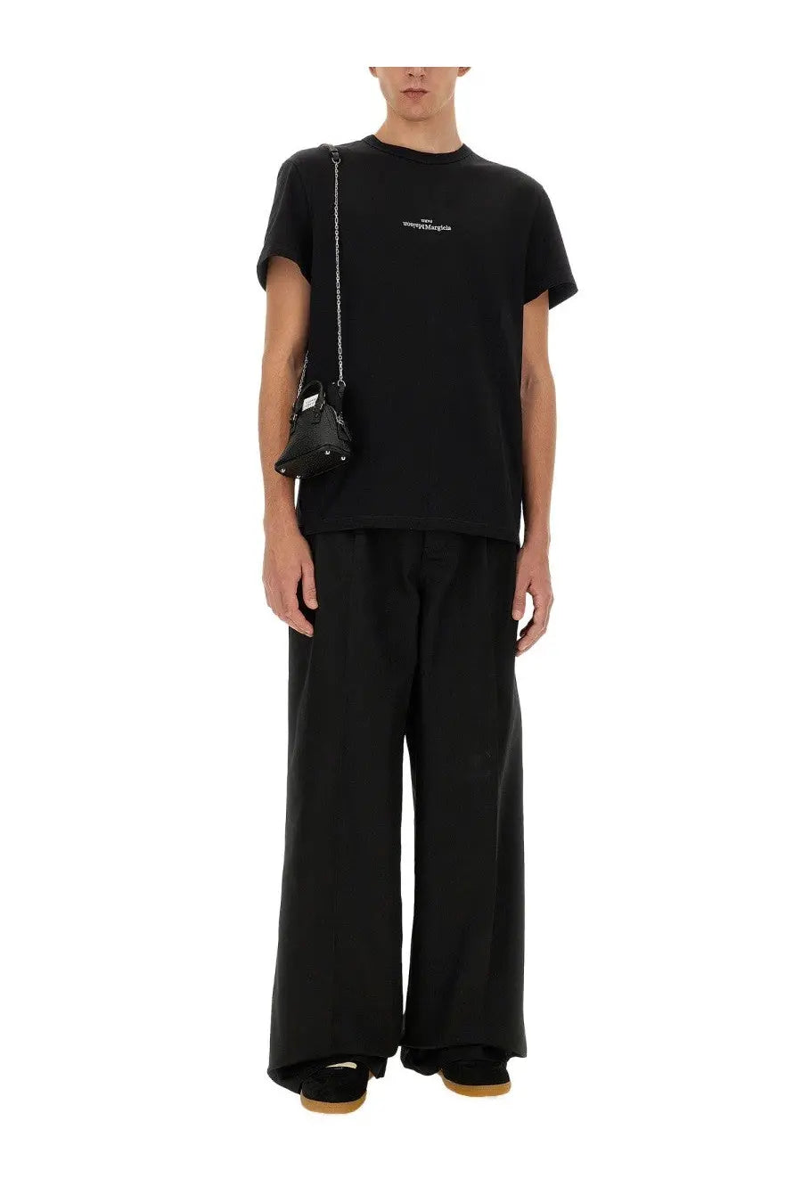 Black leather mini bag with silver chain strap and white logo detail paired with maison margiela black cotton shirt