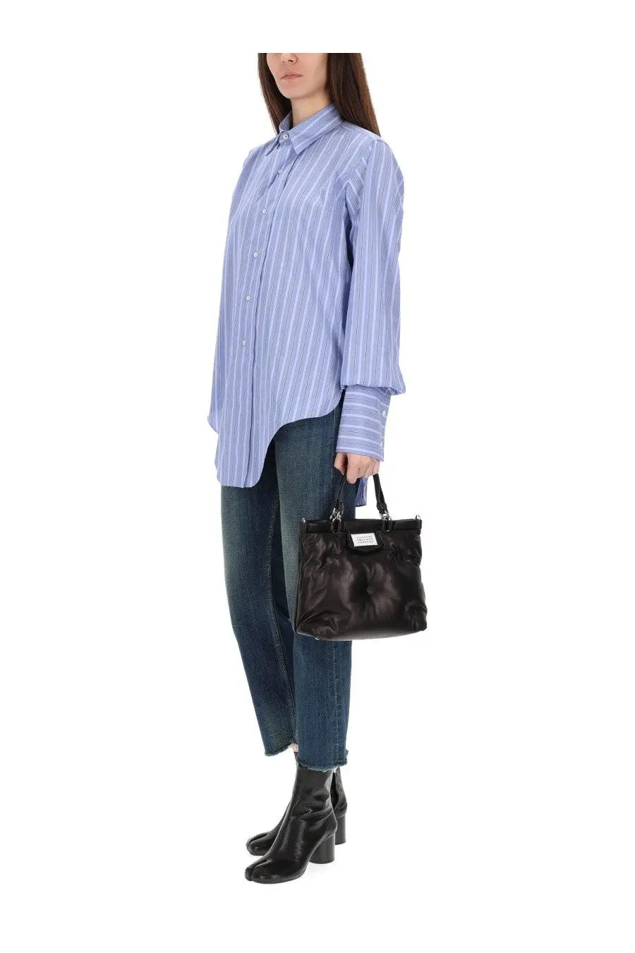 Black leather tote bag with tufted detailing and small rectangular label front paired with maison margiela blue cotton shirt
