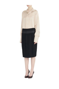 Beige satin blouse paired with maison margiela women’s four stitches midi skirt in black pleated fabric