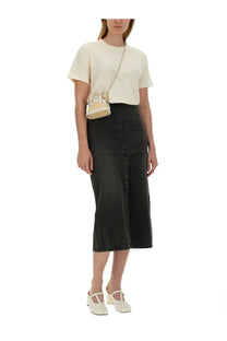 A cream-colored mini handbag with a chain strap and structured design shown with maison margiela women’s pink jersey shirt