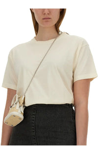 Maison margiela women’s jersey shirt pink with cream-colored woven straw mini bag featuring white leather trim and silver hardware