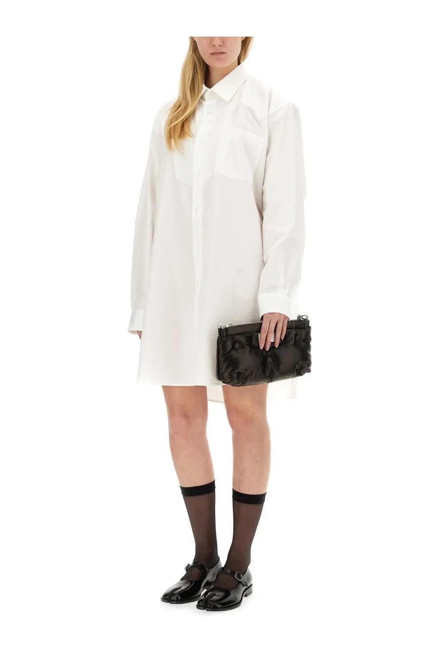 Black quilted leather clutch bag paired with maison margiela women’s white shirt dress front view