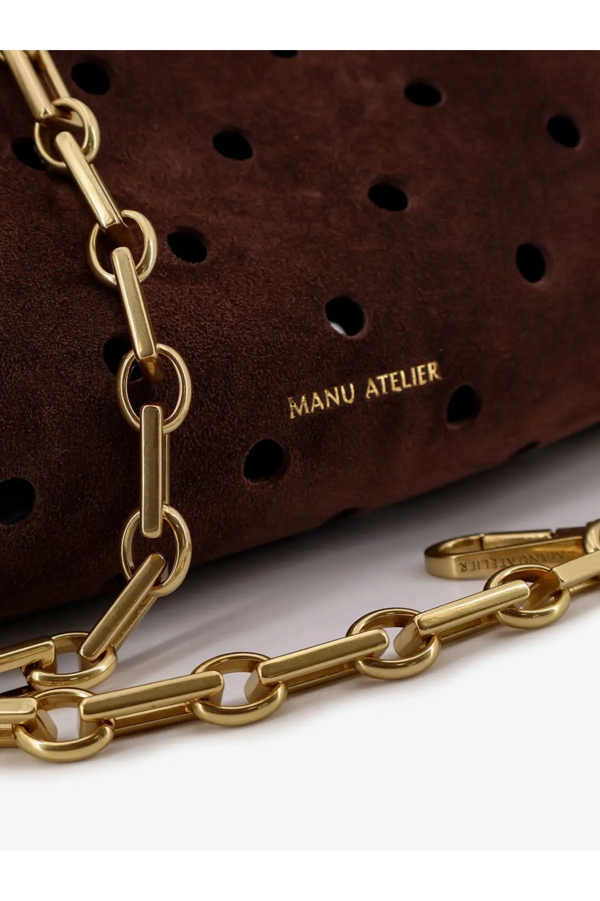 Manu Atelier women’s mini cylinder suede crossbody bag in brown with gold-tone paperclip chain and perforated design