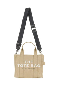 Beige canvas marc jacobs women’s borsa the tote small with black adjustable strap and white lettering