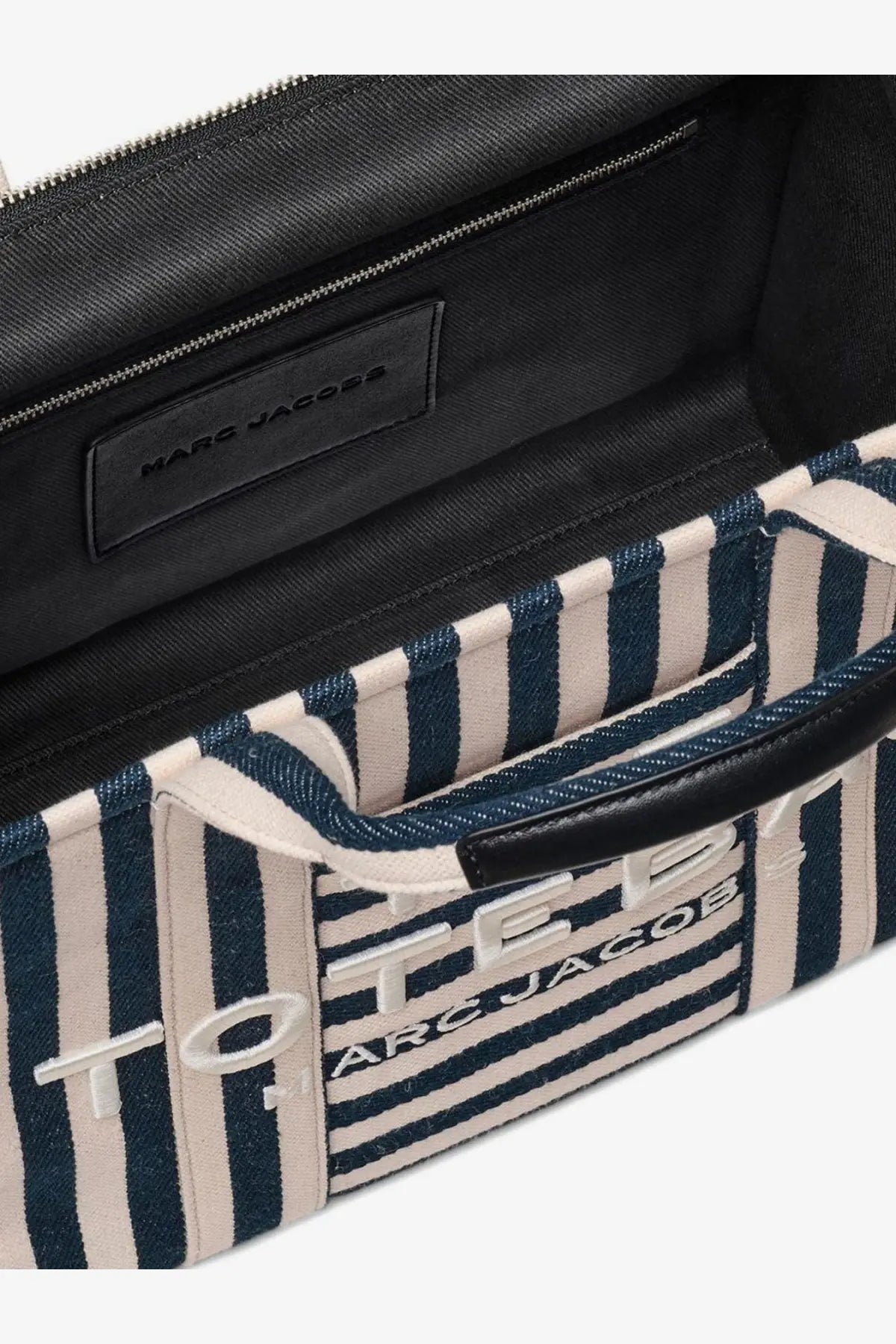 Marc Jacobs women’s navy and cream striped canvas tote bag with black leather accents and embroidered logo