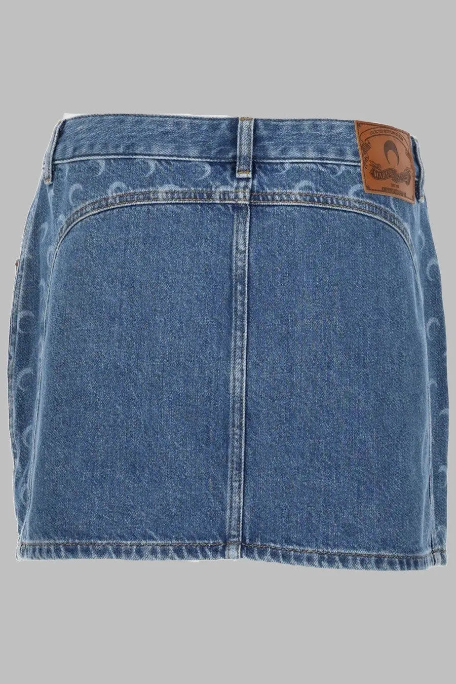 Back view of marine serre women’s blue denim mini skirt with subtle pattern and brown leather brand patch on waistband
