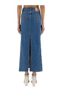 Blue denim maxi skirt with central front slit and subtle embroidery on back pockets shown from the back view