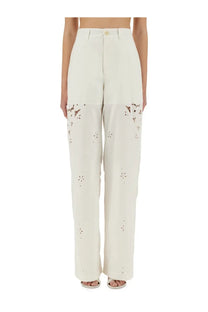 Cream-colored wide-leg upcycled linen pants with floral cut-out detailing on lower legs by marine serre
