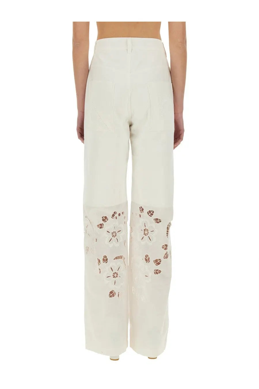 Cream-colored wide-leg upcycled linen trousers with delicate brown floral embroidery on lower legs by Marine Serre