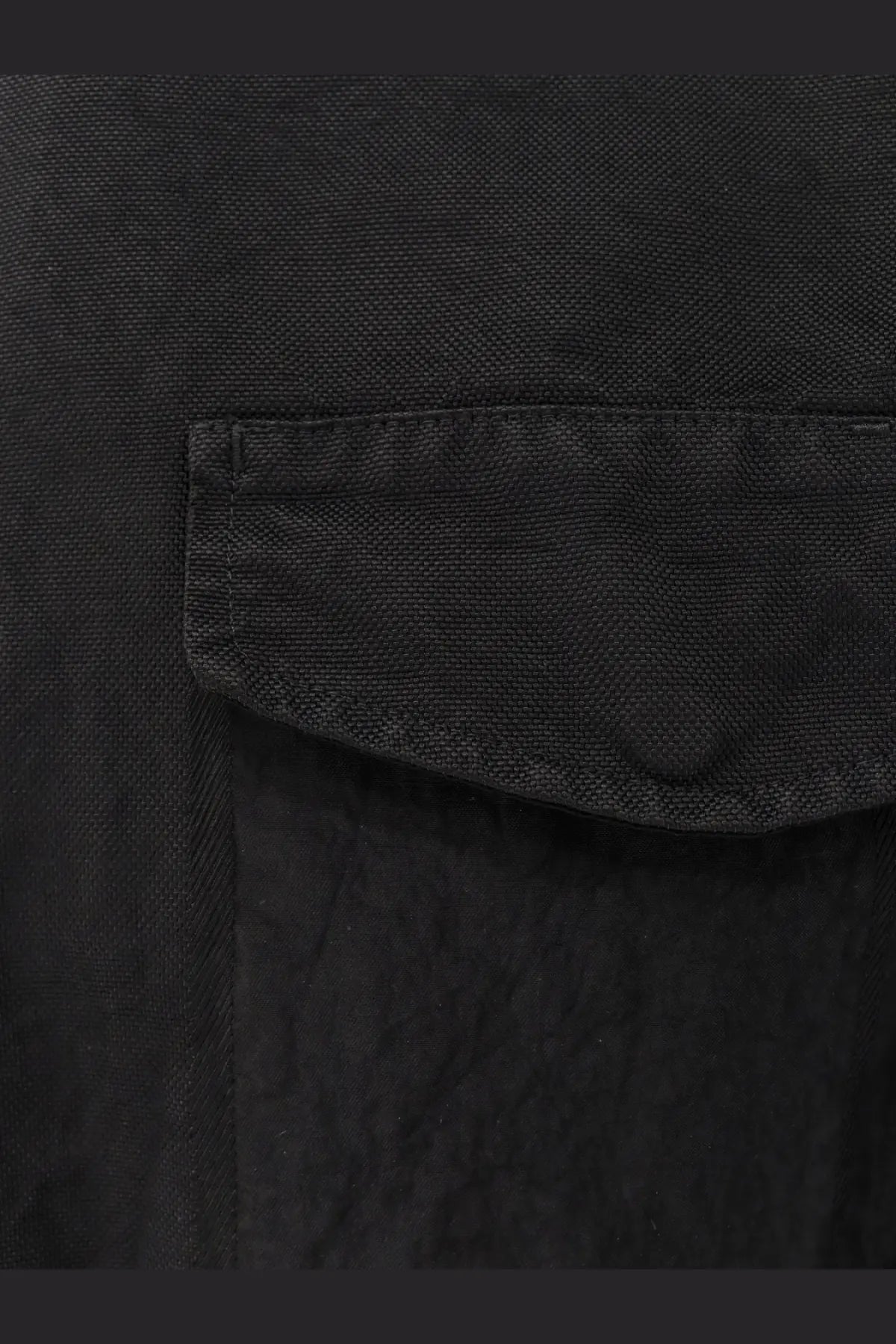Black textured fabric with subtle woven pattern on massimo osti men’s econyl regenerated nylon work jacket black