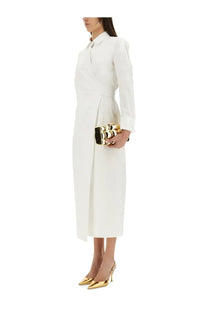 Gold and black metallic clutch with bold raised lettering paired with max mara women’s balzac long white dress