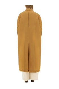 Back view of max mara women’s sack beige coat in mustard yellow with central seam and wide sleeves