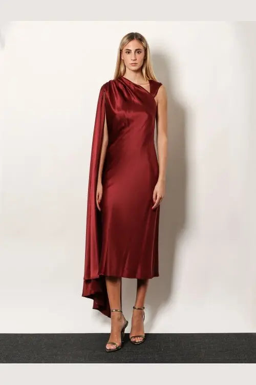 Max Mara women’s Edolo silk dress in red featuring a sleek satin finish with a draped cape sleeve and asymmetrical hemline